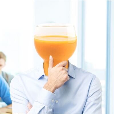 student with orange juice head
